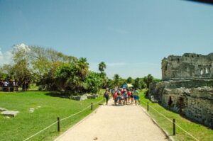 Tourists walking thru the Archaeological Zone of Tulum