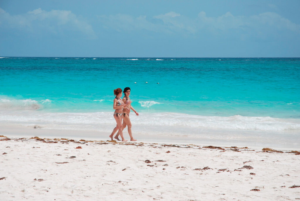 A couple of Girls strolling at Tulum beach