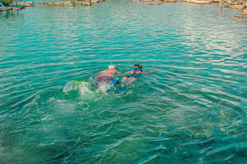 A couple of elderly lovers doing snorkeling